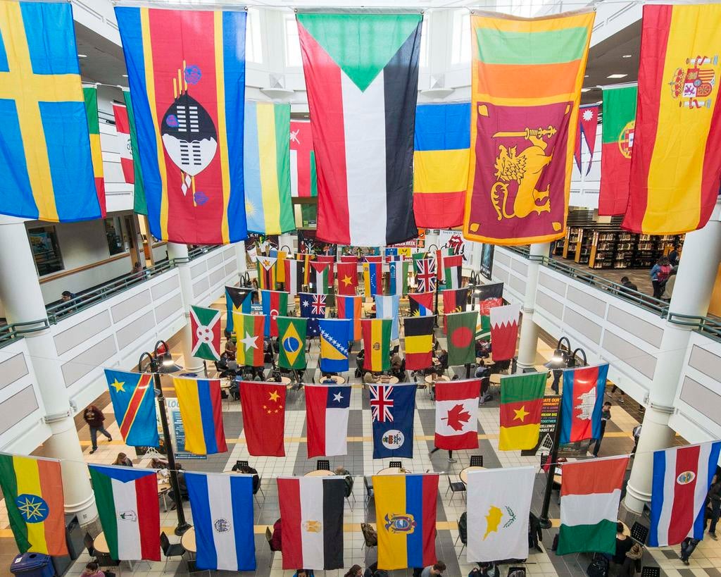 The colorful flags of different countries hang from the ceiling of the Johnson Center.